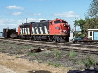 The fuel train was zipping right through town, no meet or stop on this day. A few interesting cars lead the 12+ tanks. 2 gondola loads of pipe for the oil field and a flat car of ties. Cab 79836 at the end, photo time 10:45.