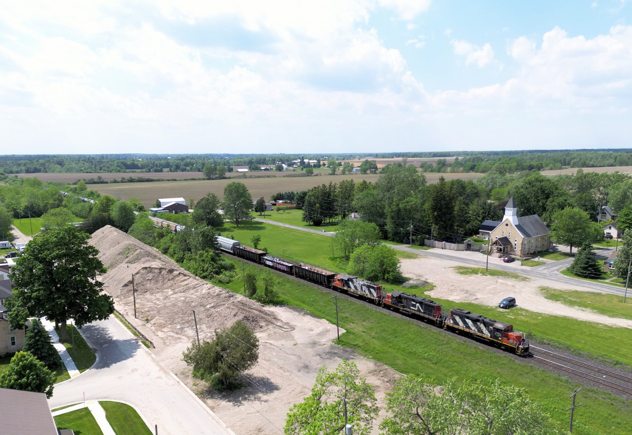 CN's London East, ON to Paris West, ON e/b turn makes a quick stop at Princeton to cut clear of the crossing to service the third customer of the day Stubee's Cement. They will pull four and spot three and then head over to Paris to run around their train and head back to London switching out a fuel transload facility in Woodstock. Several customers in the area take a wide variety of cars, today some CPKC & UP hoppers and scrap metal from Woodstock make up the headend traffic of 23 cars. 

Today this train has GP9rm 4038 + 7038 & GP38-2 4717 provide the power.

May 23, 2024
~MP 37.7 Dundas Subdivision (Princeton, ON)~