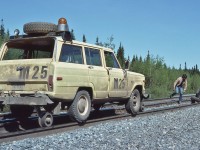 <br>
<br>
Working on the iron ore road with a Jeep Cherokee hi railer.
<br>
<br>
Cartier Railway near mile 10 South Sub-Division, June 8, 1981 Kodachrome by S.Danko.