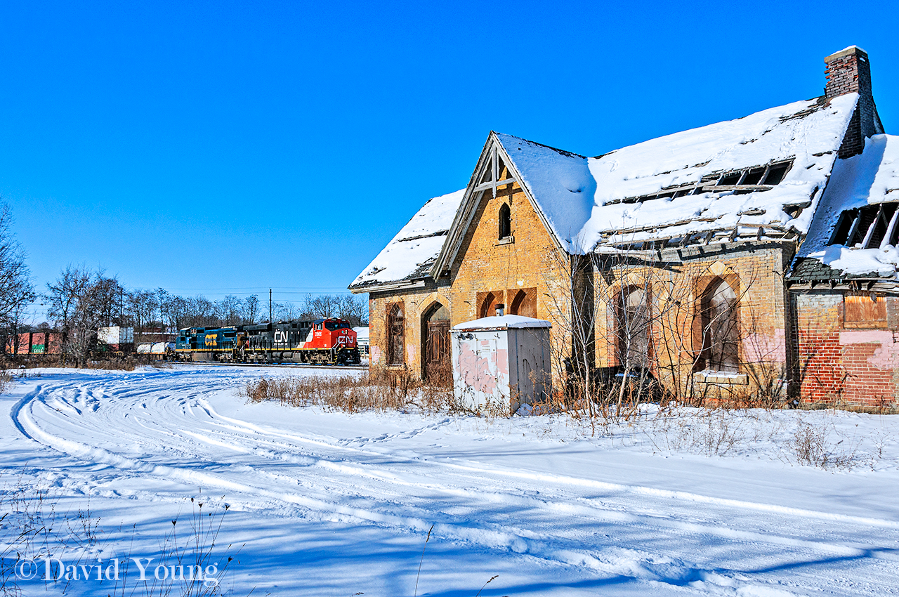 CN 148 with CN 2866 and ex CSX Dash 8 GECX 9147, slows to a crawl to protect the Thames Street crossing. In the foreground, the old Ingersoll station whose roof was barely intact on this visit in 2017. It would continue to rot, fatigue and eventually fail. On December 8, 2020 a pair of excavators were called in to demolish the century old building.