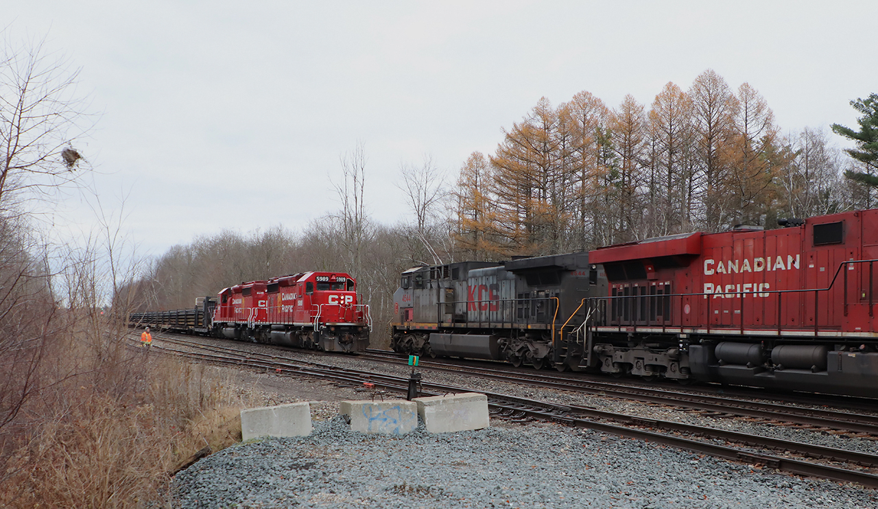 The CWR train sits waiting on the North track at Guelph Junction for CPKC 134 to pass to continue on its way west. I heard that CPKC had a KCS leader but when the grey KCSM 4544 showed I was very happy. An SD40-2 (CPKC 5989)and a KCSM "grey ghost" (KCSM 4544) in one shot. Here, the pair meet just past Milburough Line with the crew of the CWR out for their inspection.