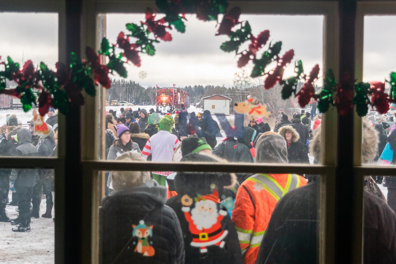 Despite thick clouds and occasional flurries, it's a big crowd waiting for the 2024 CPKC Holiday Train's stop in Cartier, ON. The former CPR station, now used by Via, is open for people to warm up and swap a donation for some hot chocolate or a baked good. These small-town stops are incomparable to the big cities, for all the right reasons.