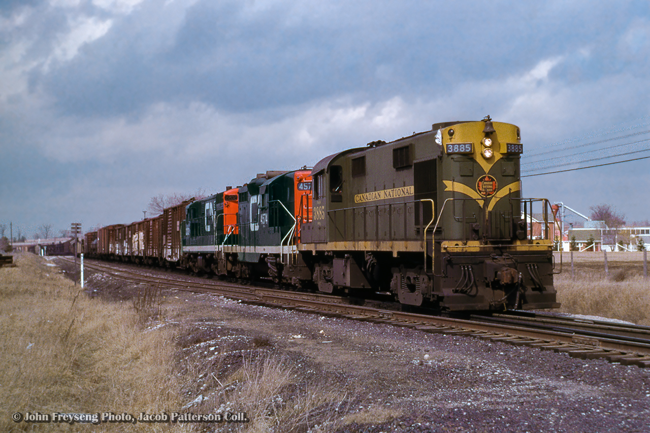 Three units from three builders.  An MLW RS18/GMD GP9/CLC H16-44 consist lead extra CN 3885 south on the approach to Doncaster where it will swing west onto the York Sub and head for Mac Yard.

John Freyseng Photo, Jacob Patterson Collection Slide.
