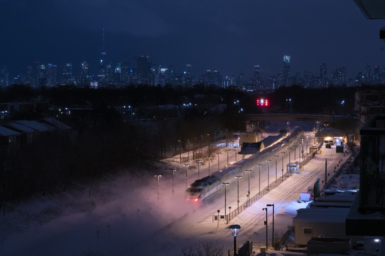 A late evening equipment train speeds through Danforth westbound and into the heart of downtown Toronto, leaving a flurry of powder in its wake...