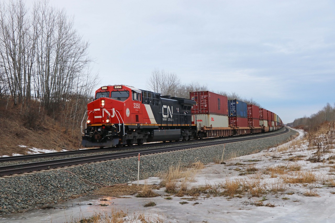 Heading from Toronto to Prince Rupert, CN 3350 leads a 146 platform intermodal train west from Stony Plain, assisted by DPU 2784.