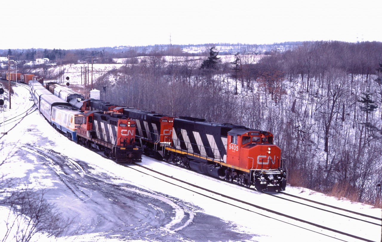 Throughout their careers, VIA's LRC locomotives were plagued by reliability problems--especially in the early years. In fact, many were removed from service as VIAs F40PH-2D units became available to cover corridor schedules in the late 1980s and early 1990s. (A few hung on until the P42s were delivered in 2001.) On this January day in 1983, CN GP9 4120 has come to the rescue assisting Toronto-Windsor train 72 through Hamilton West as it passes an eastbound CN freight led by GP40-2LW 9405, M420W 2548 and M420W 2536. Also note the Tempo passenger cars.