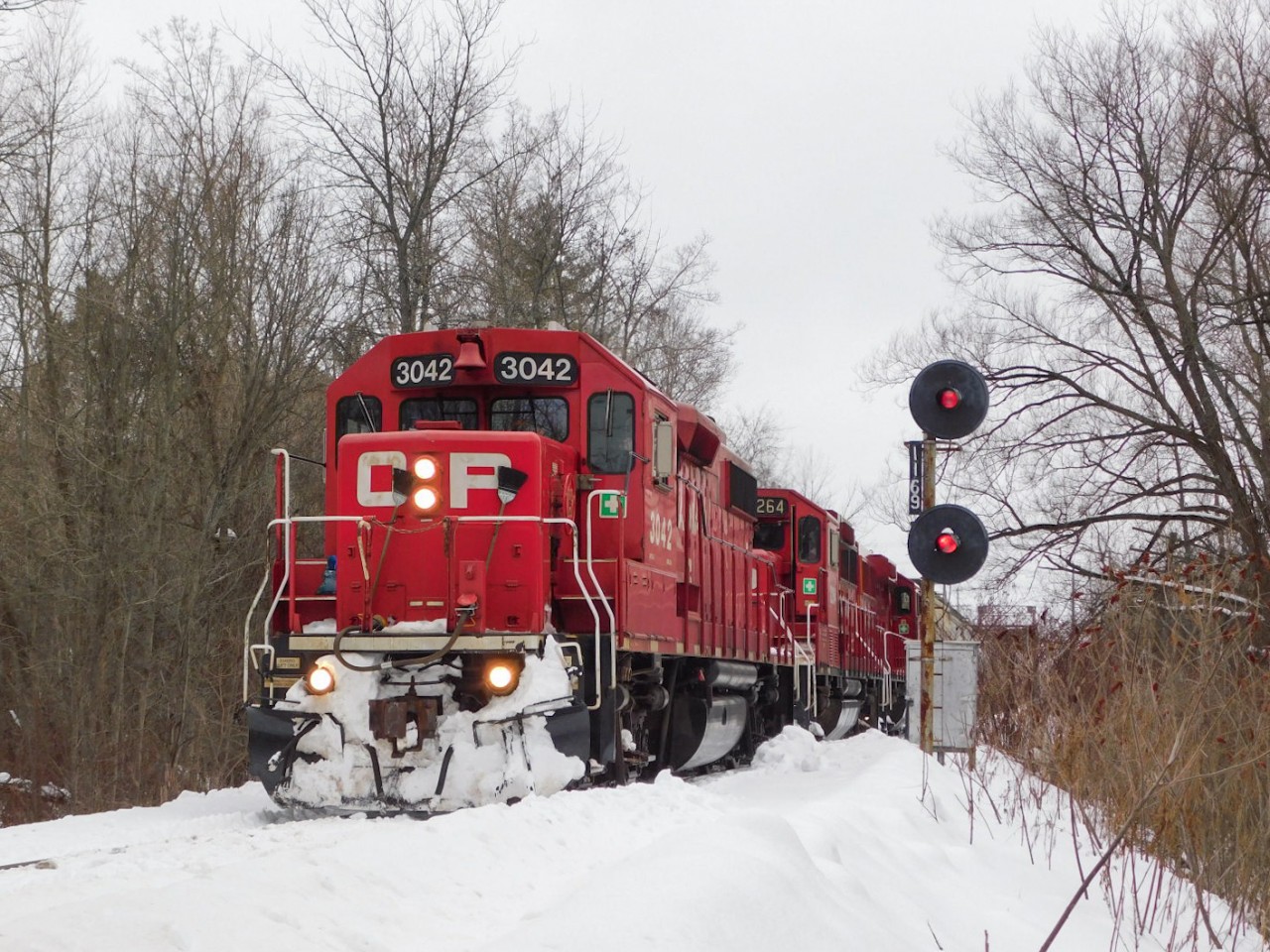 CPKC H08 passing the Trent interlock signals on its way east to Havelock with a nice GP38 leader.