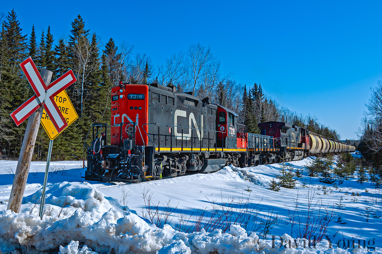 Pumping air on a pair of rusty rails, in the middle of the bush northeast of Thunder Bay. The last freight rolled off this line on May 16, 2005. This day in March of '08 found CN GP9RM 7218- S-3 slug 268- C44-9W 2666- the power having arrived in Thunder Bay earlier in the morning off train A436, now working a morning extra charge air through 113 stored aluminum CNWX hoppers along this abandoned rail line- stored since 2006. The cars being pulled off the line, destined for the scrapper in Thunder Bay. The line would be ripped up in sections starting in October 2008 with a rail train to haul the rail to various destinations on CN's network.