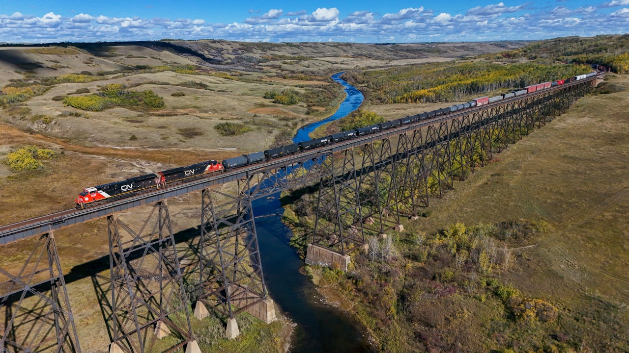 A different angle of the impressive Fabyan Trestle as M 34791 27 departs Wainwright after a crew change.