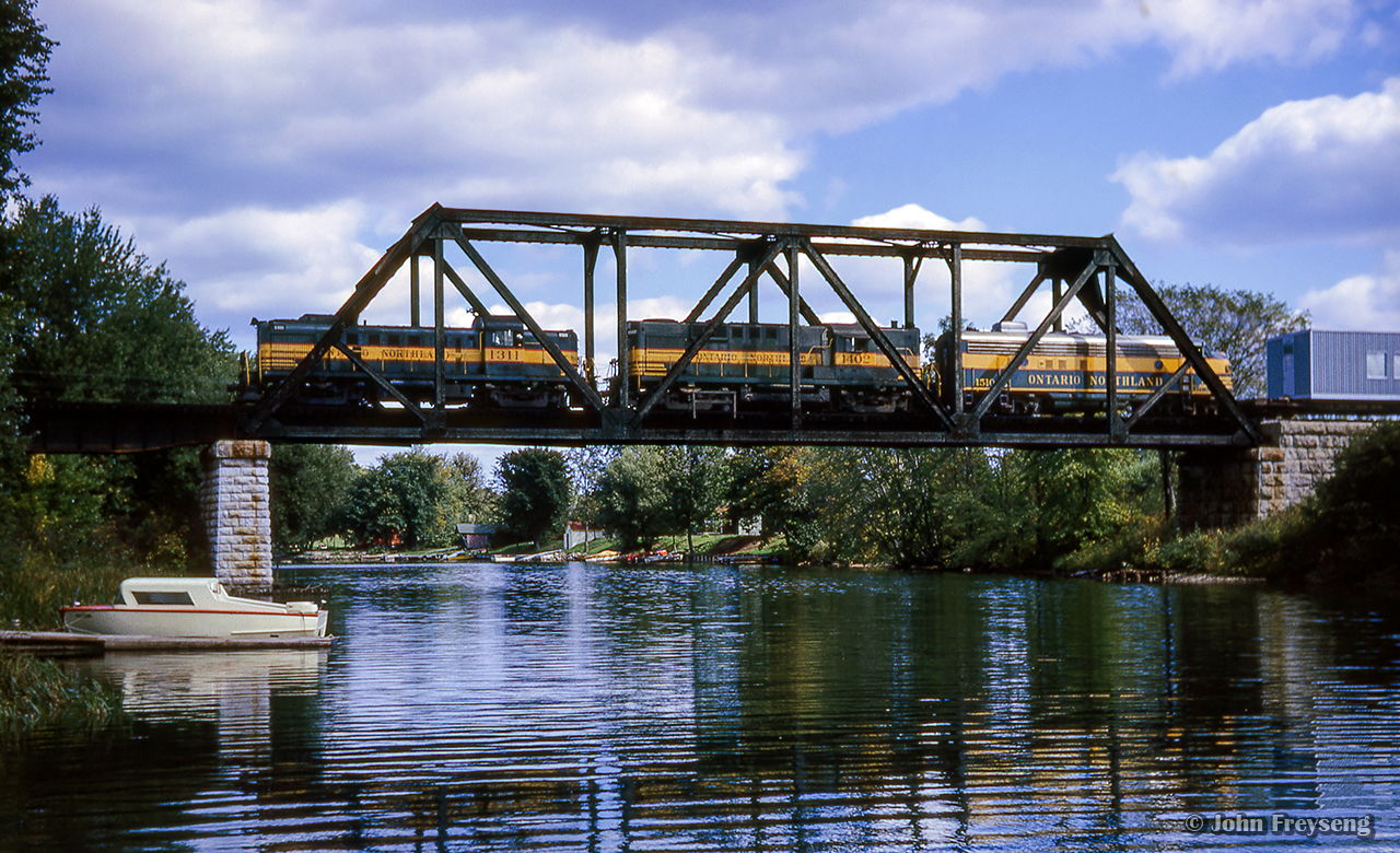 Just North of Washago on CN's Newmarket Sub, Toronto - North Bay train 459 rumbles over the Severn River.

Scan and editing by Jacob Patterson.