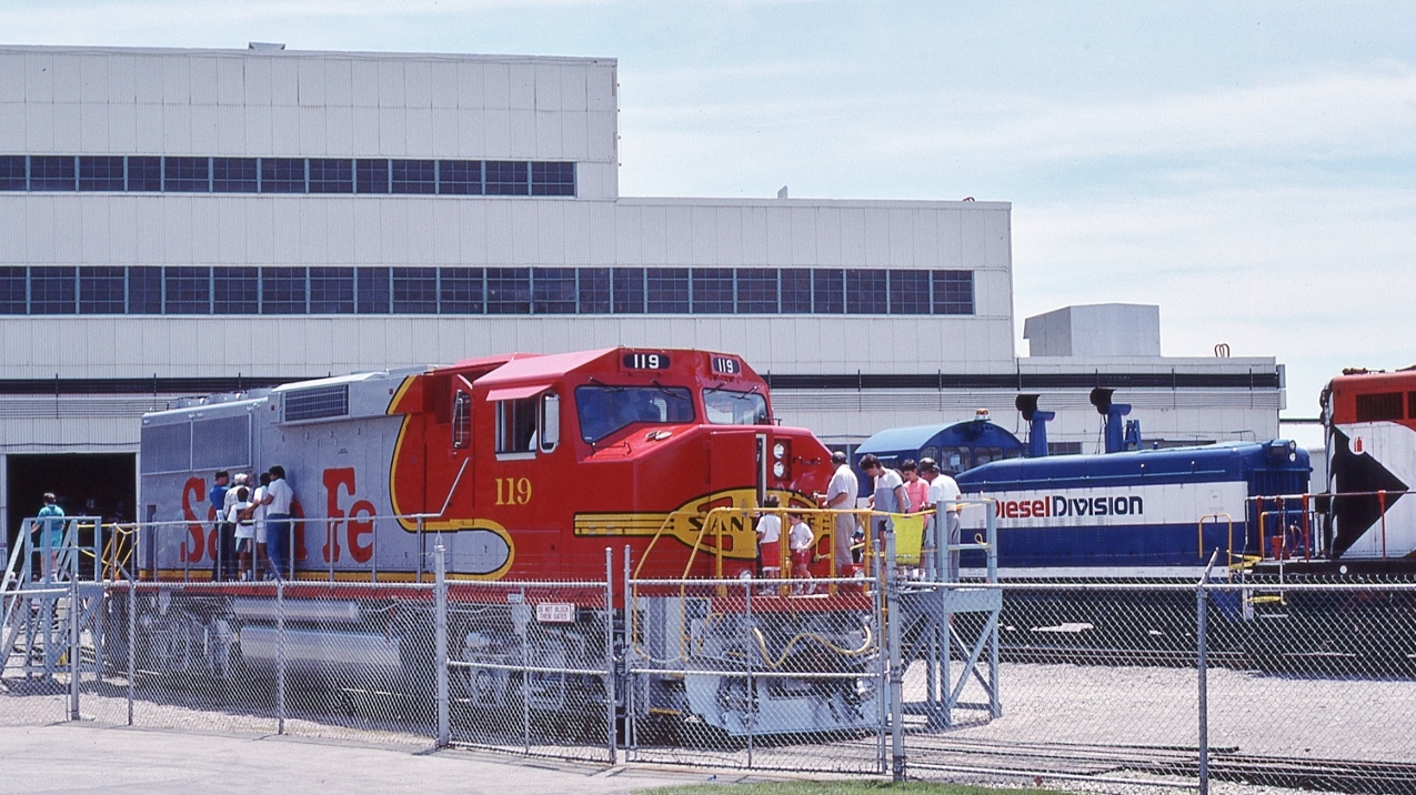 classic livery ...originally designed for the first generation units...


 and to see a second (third?) generation unit in the warbonnet livery...quite special,


GMDD GP60M  ATSF #119  on display for guests' inspection


At GMDD London Open House, June 16, 1990 Kodachrome by S Danko


And in the background:


GMDD #57, SW9 serial #A123 built by GMD January 1951 for the TH&B, acquired May 1989


plus an unknown CP Rail unit # ? , anyone?


and a lament....
 

 …. once upon a time Canada had three major diesel locomotive manufacturers: CLC Kingston (F-M licensee), MLW Montreal ( ALCO licensee) and GMDD London (EMD licensee).....market influences along with federal government policies (absent, weak and/or lacking thereof).....now all extinct....