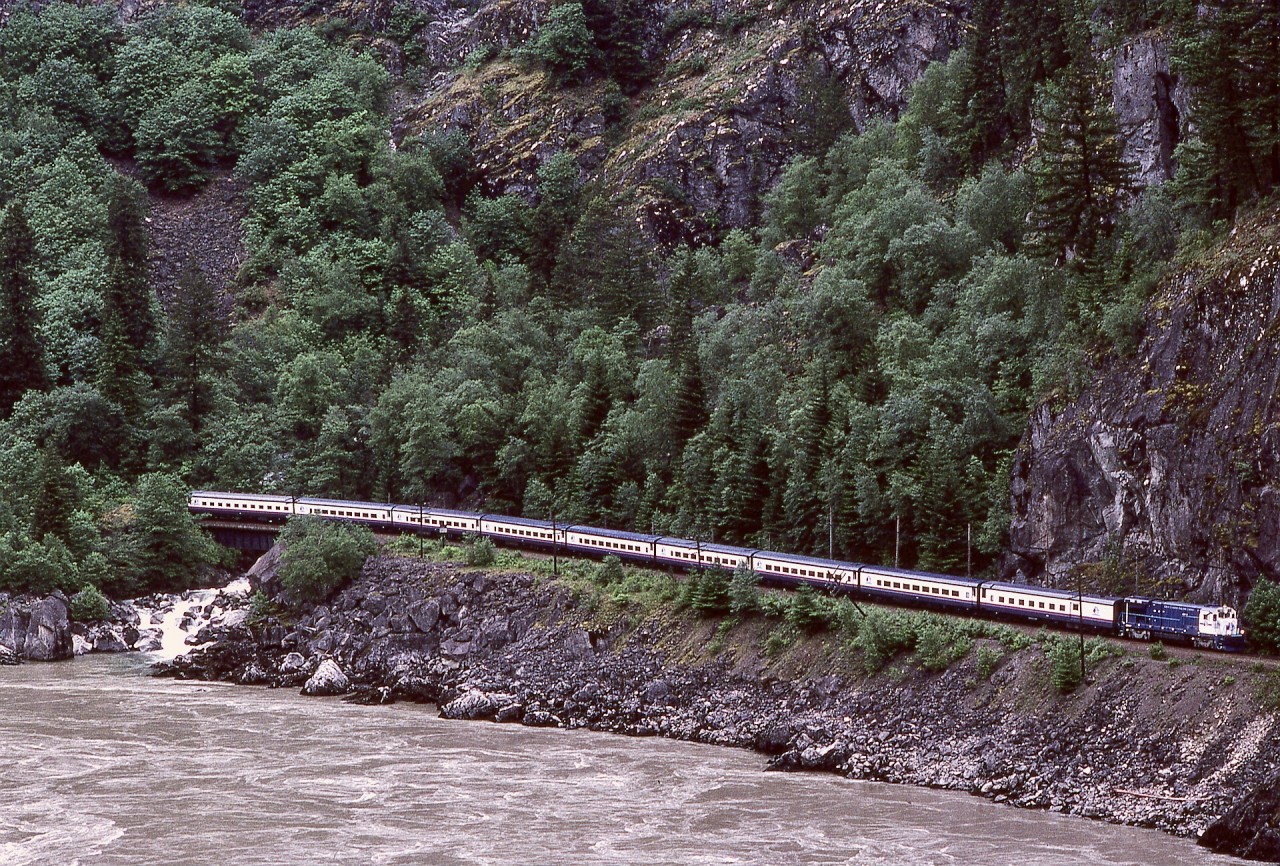In the Fraser River canyon, CP’s Cascade subdivision crossed numerous creeks flowing into the river, and this photo shows Whites Creek at 9.7 miles west of crew change station North Bend, with an eastward Great Canadian Railtour Company train headed by one of their two ex-AT&SF GE B36-7 units in June 1993.