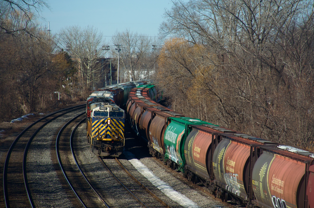 Grain train CN 874 with CN 3923 leading is passing some nice MGLX hoppers that are parked on the Transfer Track of CN's Montreal Sub.