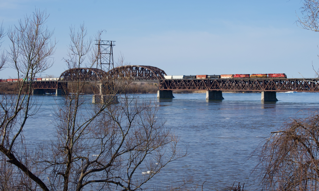 CP 9358, KCSM 4872 & CP 9835 is the power on CPKC 229 as it crosses the St. Lawrence River with tonnage from the D&H.