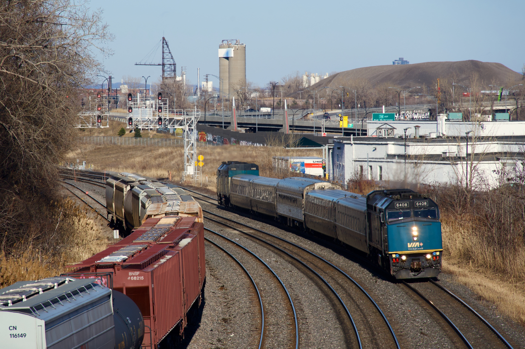 VIA 37 has two LRC cars and an F40 on either side of a single HEP car as it heads west with VIA 6408 up front and VIA 6405 on the tail end.