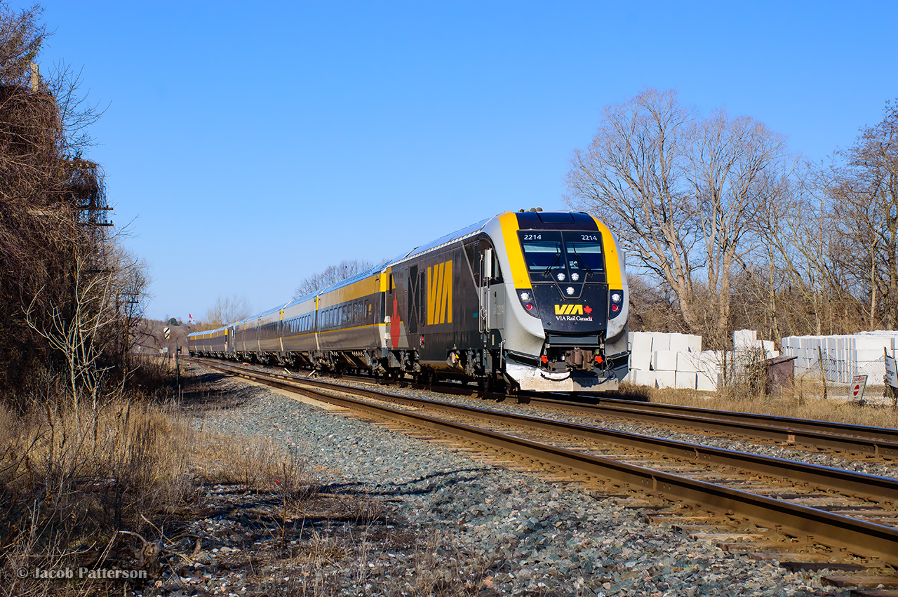 An entry to the time machine challenge alongside John Freyseng's 1963 image.With clearance through a foreman's limits just to the east at mile 289, VIA 62 and 52, running joint to Brockville, fly through Bowmanville, passing the former site of CN's station.  Constructed by the GTR circa 1856, Bowmanville's station was damaged in a January 1968 derailment, but repaired for another another decade of service into 1979.  Demolition would follow in 1981.  A small yard sat to the north of the station here, plus the Bowmanville Town Spur, running north to the Goodyear plant.