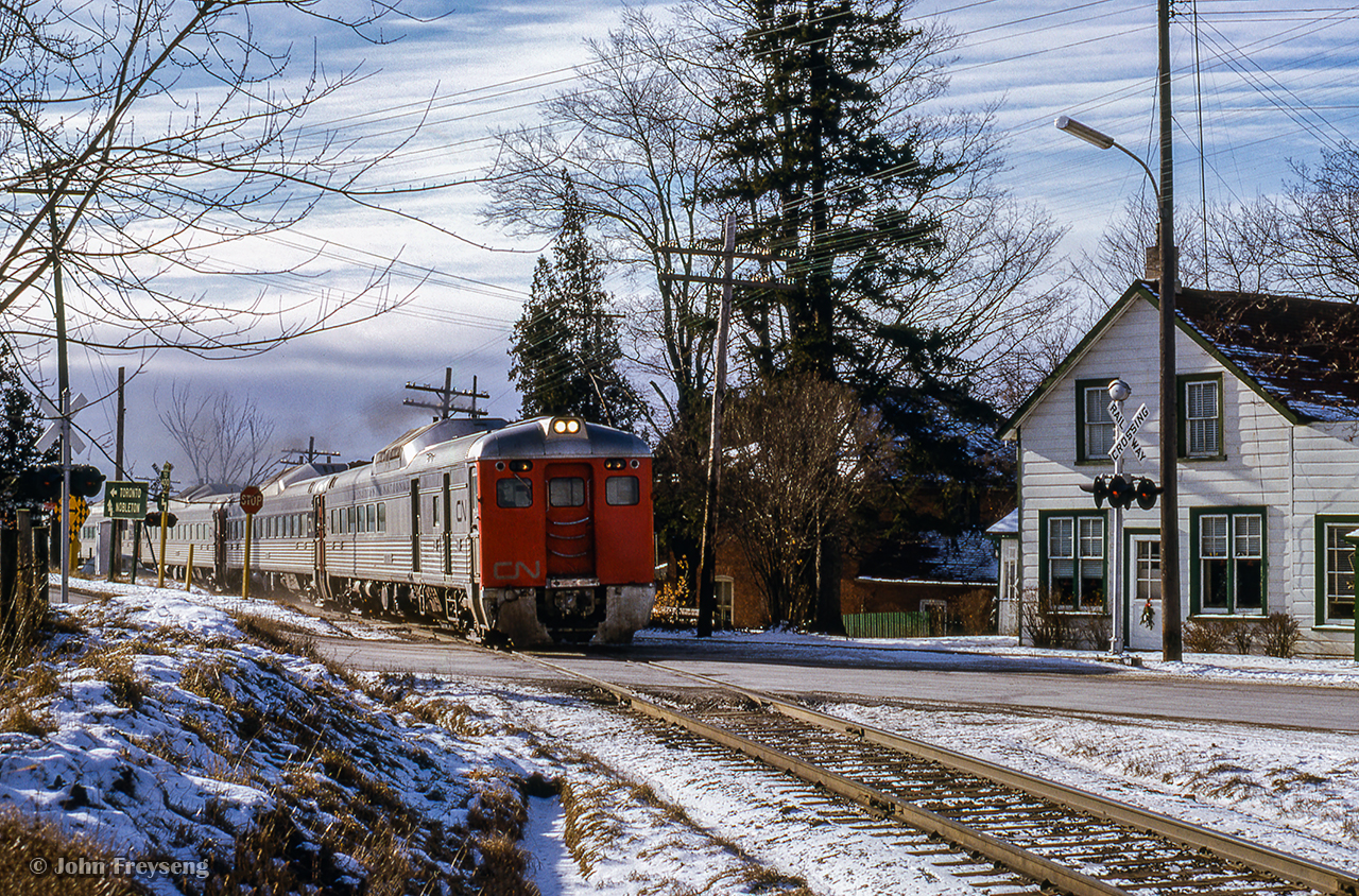 Toronto - North Bay Budd cars head through King City, cutting across the King Road and Keele Street crossings.

Scan and editing by Jacob Patterson.