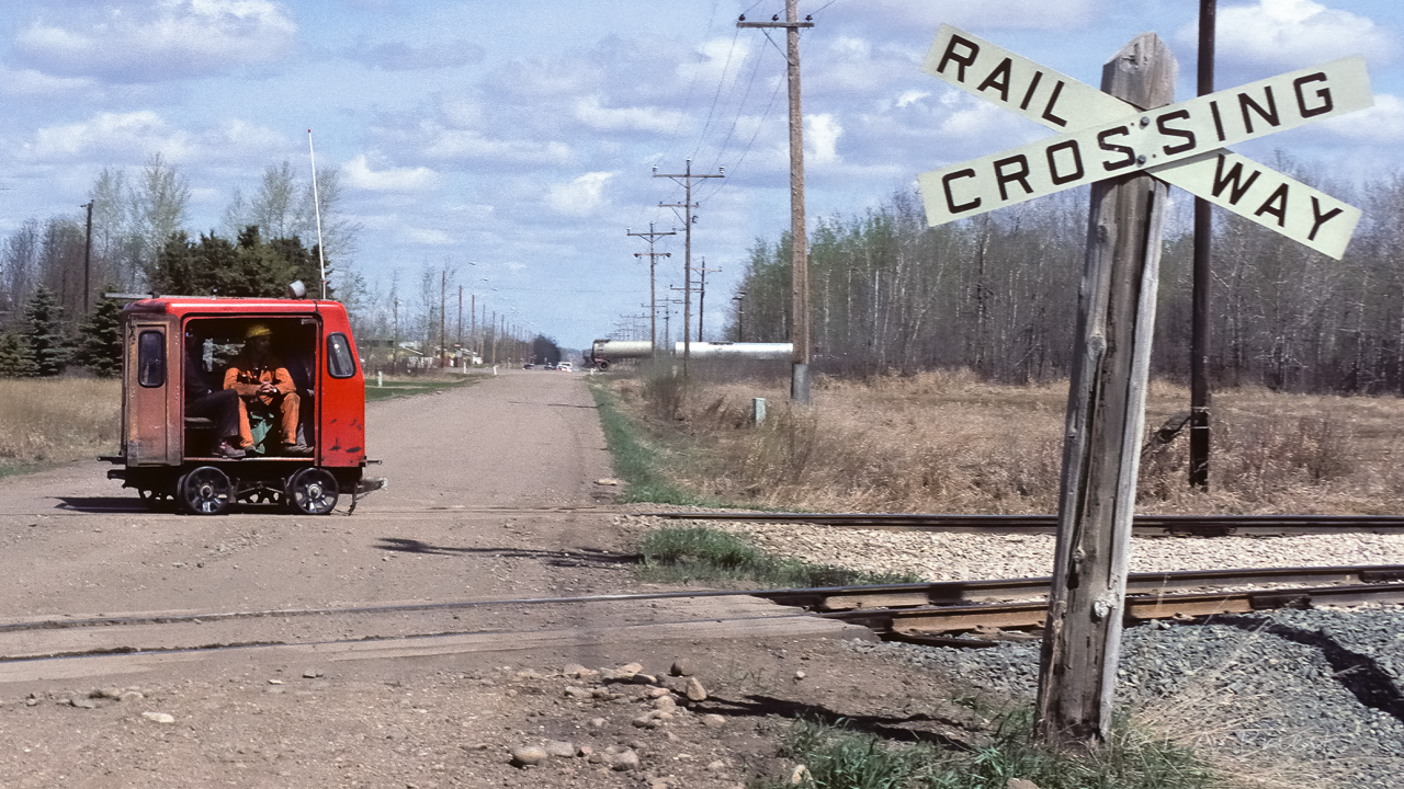 Back when signs and posts were a serious matter. The girth on the post, cars will likely bounce off of it. Plus, the bold "Railway Crossing" printed on the sign. There were 2 signs with big posts in the Redwater area, this one just west of town and another down by the river and trestle. Also, a bonus back at this time, was having these little buggies full of men go zipping by on occasion. Sadly, the posts and signs were replaced shortly after this photo was taken (The standard reflectorized sign with red trim lines) and the speeders left just a few years later.