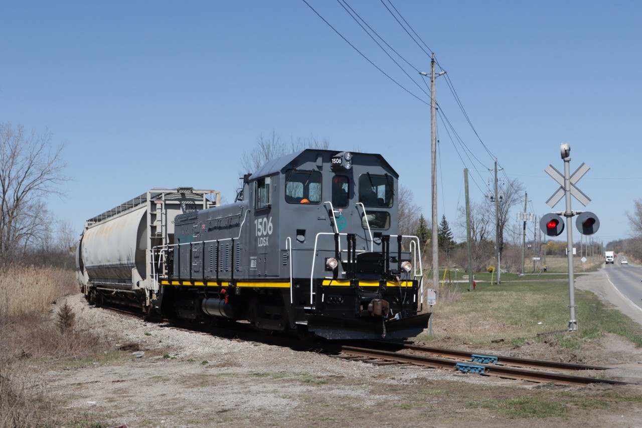 Former IC 1506 refurbished by Lambton Diesel Specialists and now wearing the GIO Railway paint scheme is heading south to Port Colborne with three hoppers in tow.