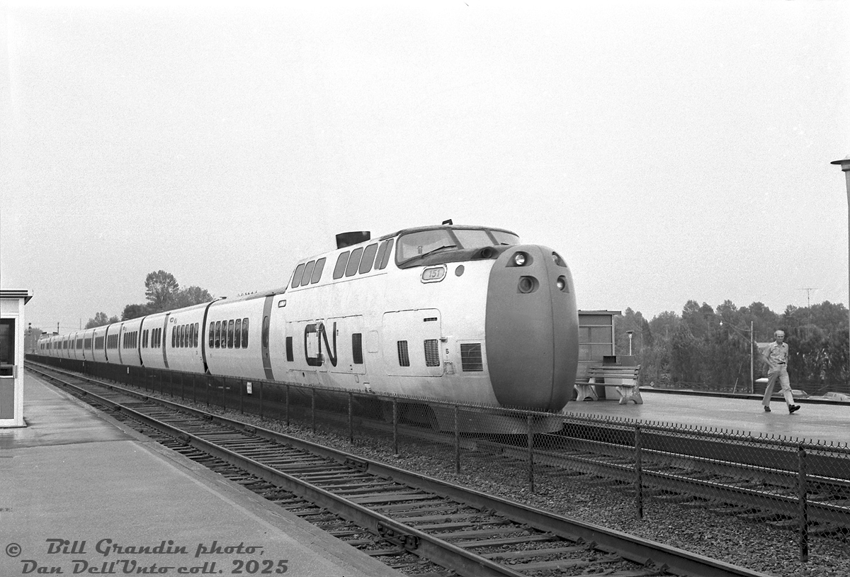 Turbo Power! A westbound CN Turbo Train lead by Powered Dome Car (PDC) 151 cruises through Guildwood GO Station in eastern Toronto (Scarborough), on the final leg of its Montreal-Toronto journey.

The date on this one was December(!) 12th 1974, but Bill Grandin's dates can be questionable at tines. Given the short-sleeved fellow on the platform and trees in full bloom, this is more likely a Spring-Summer shot.

Bill Grandin photo, Dan Dell'Unto collection negative.