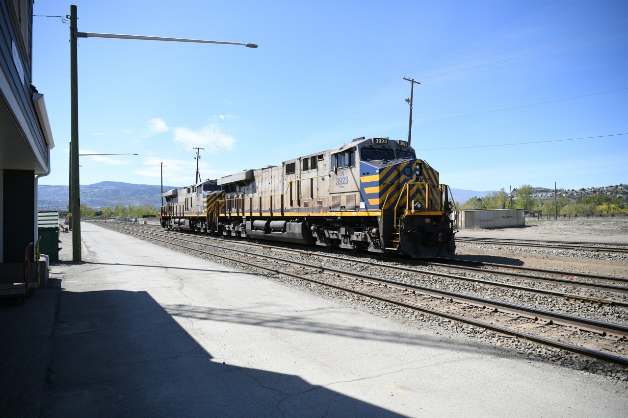 CN Silver and Blue  
Coupled elephant style, CN 3923 & CN 3951 make a reverse movement past VIA Rail's Kamloops North station towards the crossover at the west end of CN's Kamloops Yard on a very warm mid-April afternoon.