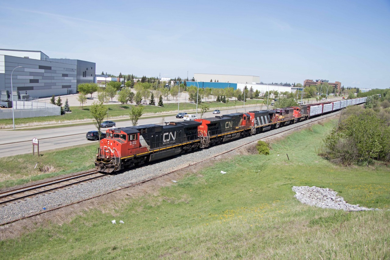 CN 41851, the daily train from McLennan, passes through the outskirts of St. Albert as it runs its final miles to Walker Yard (Edmonton) with an eclectic lash-up (DASH9-44CWL 2502, DASH9-44CW 2663, GP40-2LW 9433, WC GP40 3018, and GP40-2LW 9592). Geeps like these are the normal power on Roma Jct-Hay River trains. Also of note, the 3018 is the only WC GP40 still on the CN roster.