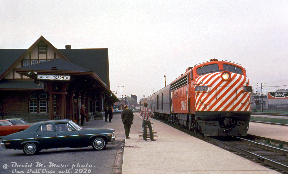 "Down by the Depot": Passengers, spectators and employees wait on the platform as CP Rail train #12, the Sudbury-Toronto leg of "The Canadian", pulls into West Toronto Station after coming down the MacTier Sub and crossing over the diamonds via the connecting track to the Galt Sub. CP FP7 4071 handles the train solo (a common practice back then for the less-patronized leg of The Canadian), with two rounded-side lightweight steel baggage cars and the usual Budd stainless steel cars trailing. The Penford Paints sign is visible on the other side of the CN Weston Sub on the right. The signals in the background were for CP's North Toronto Sub that crossed east-west at the diamonds.This routing of the Canadian in and out of Toronto shifted to taking CN when VIA took over CP's passenger services in September 1978. The closed and unused CP West Toronto Station, built in 1911, was demolished by CP without a permit one morning in 1982 under much controversy, as a local movement was under way to save it. CP 4071 later became MUCTC/AMT 1301 for Montreal commuter service, eventually ended up on the Durbin and Greenbrier RR repainted as Western Maryland 243.David M. More photo, Dan Dell'Unto collection slide.
