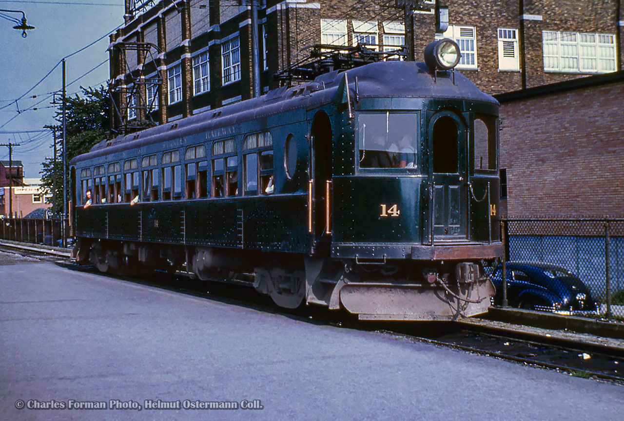 London & Port Stanley Railway interurban car 14 is seen at the railway's London station on Bathurst Street, just to the south of CN's station.

Built in 1917 by the Jewett Car Company, 14 saw service until the end of passenger service in 1957.  After spending a number of years at the Canadian Railway Museum in St. Constant, QC, 14 returned to St. Thomas as part of the Elgin County Railway Museum collection.  Volunteers of the ECRM have dedicated years of work to restore the car, and with assistance from expertise at the Halton County Radial Railway, (where L&PS 8 is operated), have restored to car to operating condition.

A joint event with the Elgin County Railway Museum and the Port Stanley Terminal Railway will take place on Saturday, March 24, 2025, where L&PS 14 will operate over the former L&PS line from St. Thomas to Port Stanley, pulled by one of PSTR's diesels.  Cheers to all involved in this undertaking.

Charles Forman Photo, Helmut Ostermann Collection Slide.