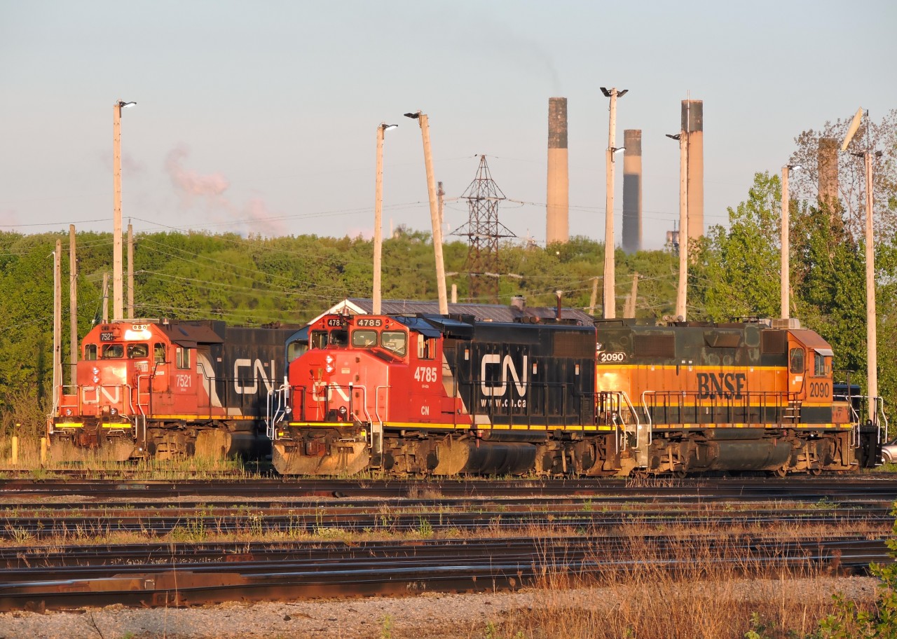 Its 6:30am and the morning sun is just coming up as yard power sets await the start of another day at Sarnia, CN 4785 and BNSF 2090, tucked in behind just barely visible is VIPX SW1200 1007 (out of service, sold to LDS?) on another track is CN 7521 with BNSF 2968 and CN 4770.