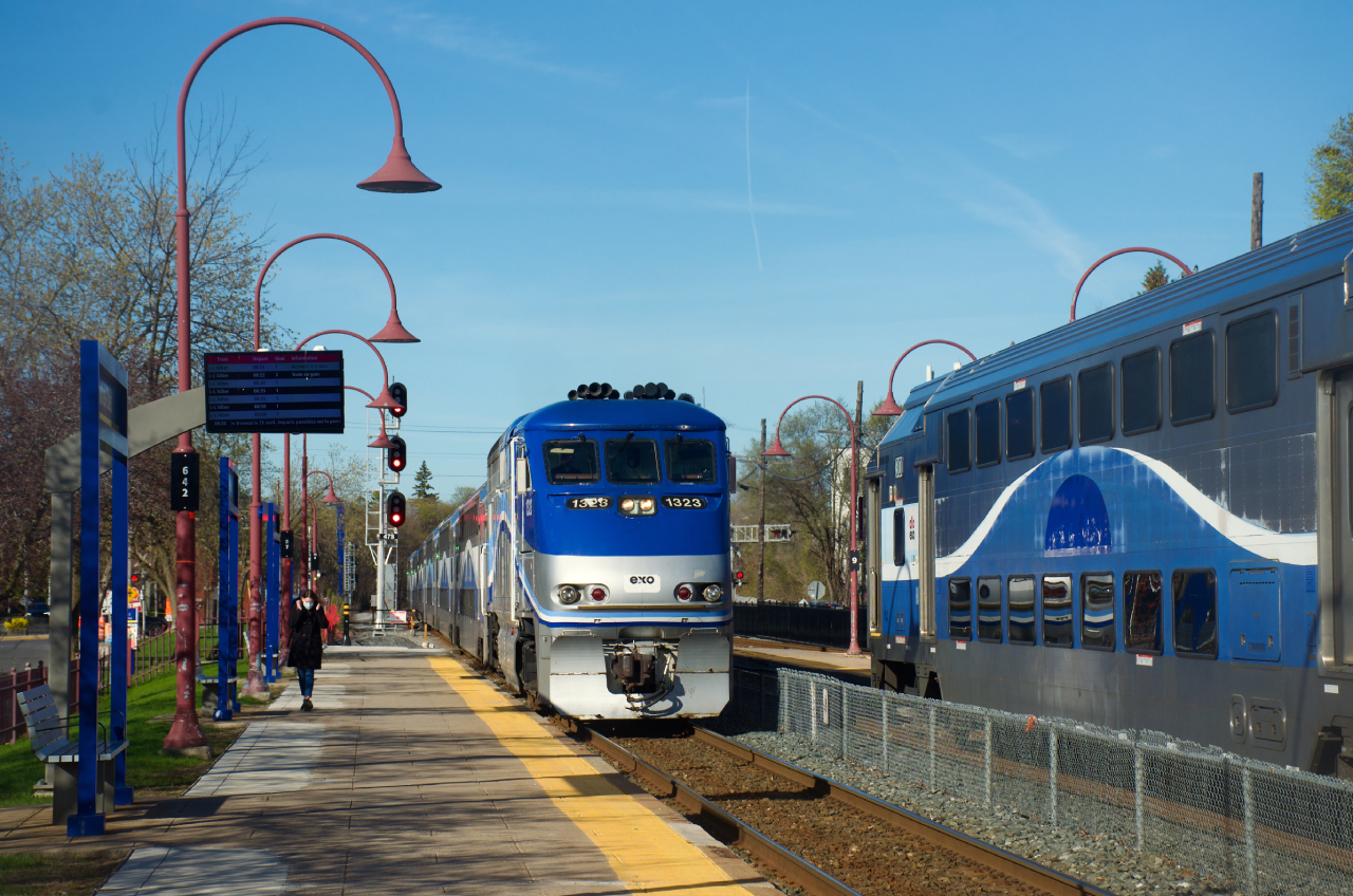 EXO 16 from Vaudreuil is arriving at Montreal West Station during the morning rush hour as a deadhead move at right awaits its signal.
