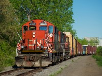 CN YRP003 is heading to GETPAQ with seven boxcars, including an Ontario Northland one, as the conductor waves from his vintage GP9 pair (CN 4140 & CN 7233). At present, this is the sole client around what was once CN's Longue-Pointe Yard.