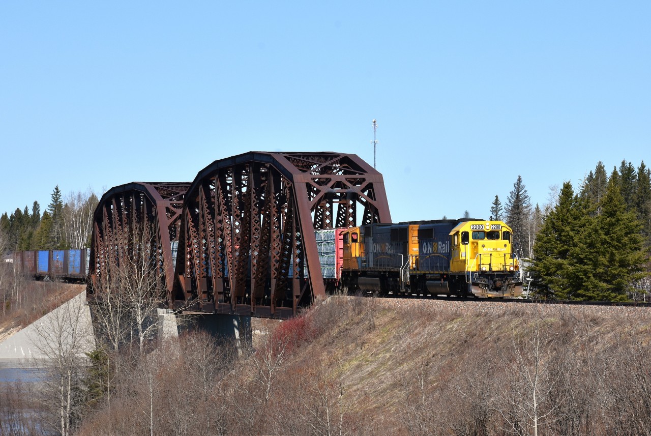After shooting the northbound PBX (Polar Bear Express) at a location north of Cochrane, it was time to 'race' down to Hwy 11 and head west to try and pick up the ONR "Hearst" local as it made its way back to Cochrane. We picked up advance warning by way of chatter on the scanner and had barely a minute to line up this shot at the Groundhog River bridge in Fauquier.  It was well worth the trip. The power is ONR 2200, 2102. This train runs three days a week from Cochrane to Kap and on to Hearst and then returns.
One thing about the ONR is one must cover a lot of distance to catch anything, but it is always worth it.