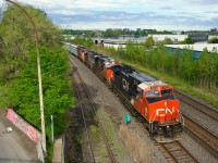 A rebuilt GE leads CN 401 west on the Freight Track of the Montreal Sub.