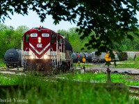 The OSR high hoods have returned. Seen through a small window in the surrounding trees, the crew aboard the ancient (former SOO) GP7's 383-378 depart CN's Flora Street yard, bound for Ingersoll.