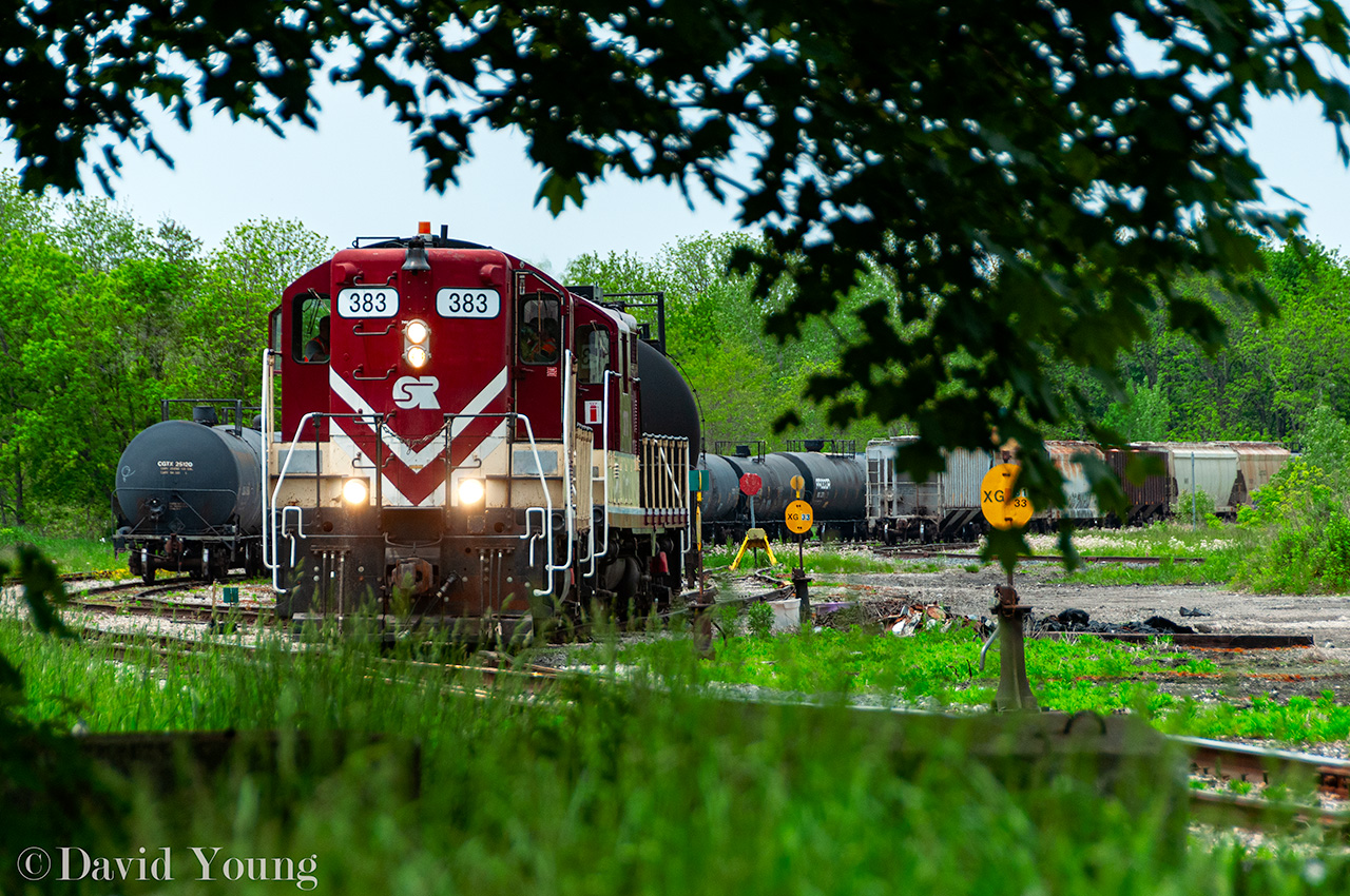 The OSR high hoods have returned. Seen through a small window in the surrounding trees, the crew aboard the ancient (former) SOO GP7's 383-378 depart CN's Flora Street yard, bound for Ingersoll.