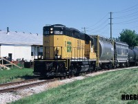 Essex Terminal Railway GP9 102 approaches the Texas Road crossing as it departs Amherstburg, Ontario on the ETR Subdivision with cars from industries that are now long gone.  During January 2005 the bankruptcy of General Chemical had ended rail shipments of calcium chloride and Don Hearn & Sons, which had a contract to bag soda ash for Allied Chemical eventually ceased using rail. Also, in 2014 Honeywell had officially closed their Amherstburg facility. However presently, Diageo Canada receives regular rail service by ETR from Windsor. 
<br>
GP9 102 was built for the Algoma Central Railway in August 1963 and was the last GP9 ever constructed at London’s General Motors plant. It was eventually purchased by ETR where it worked until it was acquired by the Ontario Southland Railway in 2016.

