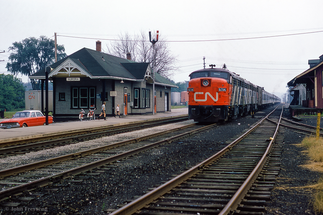 A hazy summer day finds the westbound Super Continental in the hole at Aurora, waiting on the eastbound Super to pass shortly.

Scan and editing by Jacob Patterson.