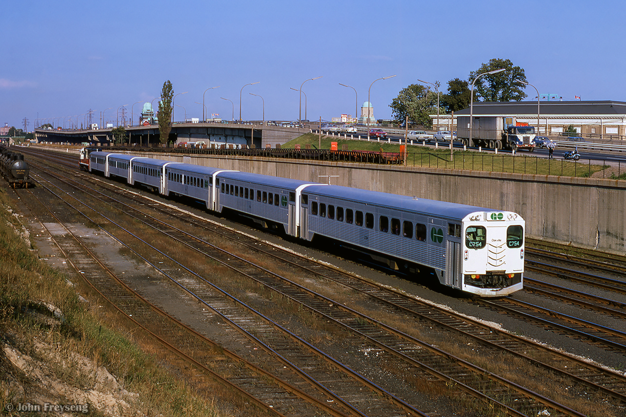 A few months after the start of GO Transit service, a westbound train for Oakville is seen approaching Dufferin Street and a station stop at the old Exhibition station.  The view here would change the following year with the opening of GO Transit's new Exhibition station (the fourth in the vicinity), would open in late 1968.

Metrolinx is currently in the process of rebuilding Exhibition station into a multi-modal station incorporating rail, subway, and streetcar service.  Anticipated completion date is 2041.

Scan and editing by Jacob Patterson.