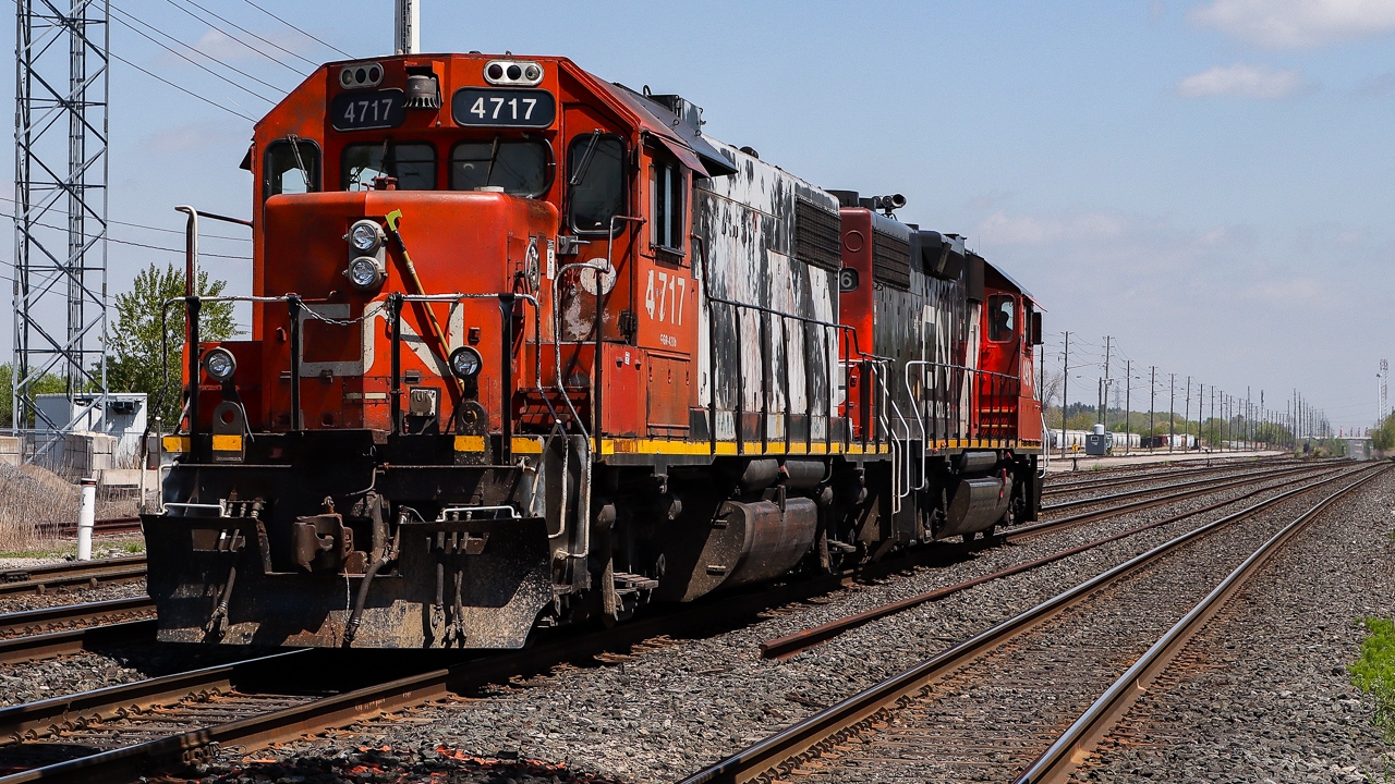 Almost 40 years after getting "zebra stripes" CN 4717 (ex-CN 5517) is looking a little tired and faded as it trails on a light power move with CN 4936 leading L554 eastward with clear track ahead to 9th Line where they will crossover and enter the Cement Lead.

Seth B. captured CN 5517 in September 1986 on the Coronado Sub. shortly after being repainted in "zebra stripe" livery. http://www.railpictures.ca/?attachment_id=46538
