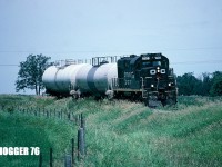 Ottawa Central Railway (OCRR) train 525E with RS18u 1838 (ex-CP 1838) is curving towards the Rabbit Path crossing at Mile 18.09 of the Renfrew Subdivision. This location is near the town of Kinburn, Ontario. At the time, 1838 was returning from the Honeywell Nylons Canada plant in Arnprior, which saw service once per week under OCRR. On April 30, 2003 Honeywell Nylons Canada Inc. had acquired the facility from BASF, including the former Arnprior-Nepean Railway (Renfrew Subdivision), which became a wholly owned subsidiary of Honeywell. Later, when CN acquired OCRR during 2008, it continued the weekly trips to the now Nylene Canada plant, still servicing it once per week with L589 from Ottawa’s Walkley Yard.