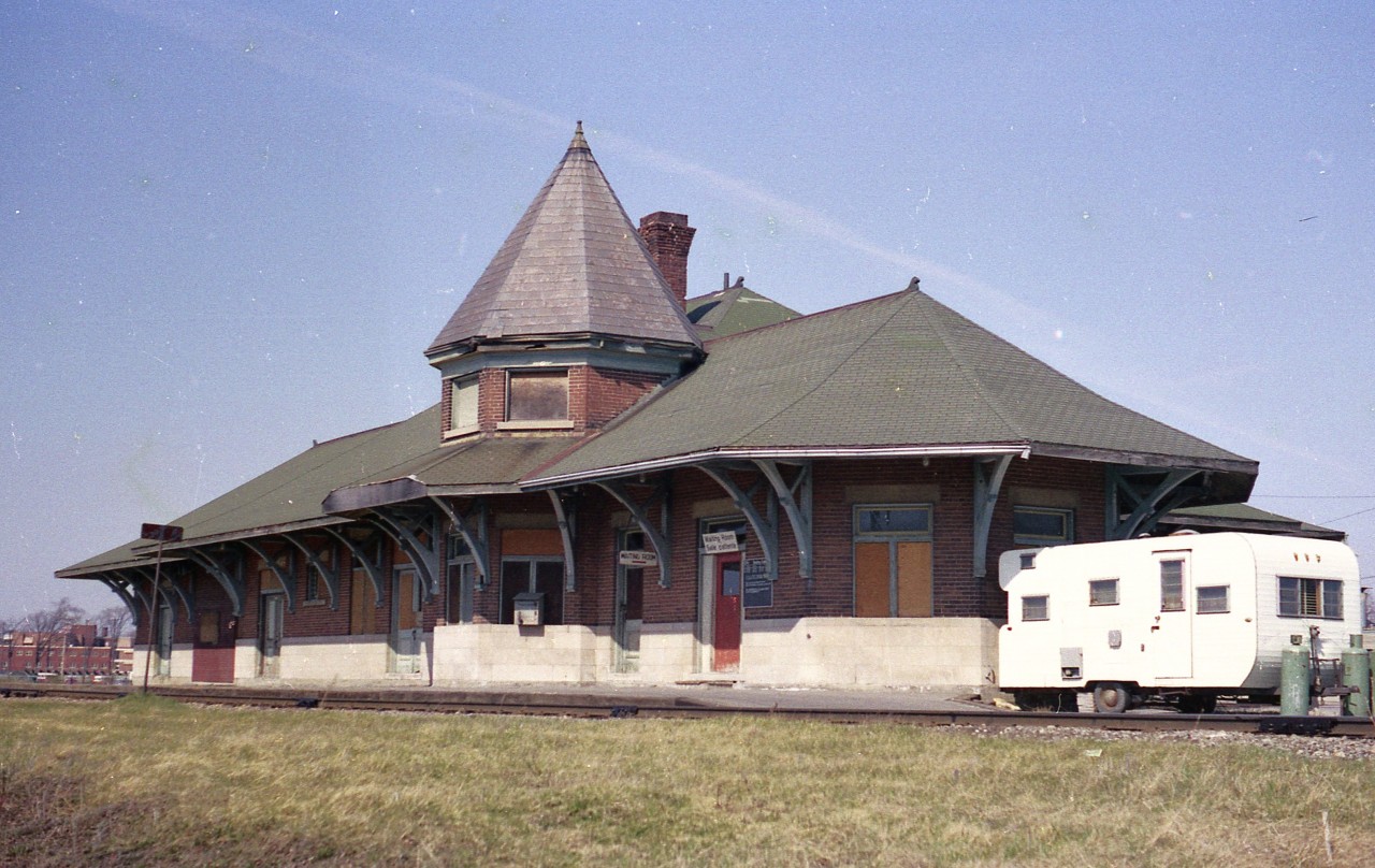 Back in early 1977 when I dropped by the boarded up Smiths Falls CN station, I would have never envisioned it evolving into the now very impressive Railroad Museum of Eastern Ontario.
Passenger service here was on its' last legs. The line was abandoned northward of here in 1978.  The station itself had been empty for 15 years before a 'Save-our-Station group, led by the C of C got the ball rolling to preserve the structure and with the fledgling Smiths Falls Railroad Museum Association, gathered artifacts and were able to open a museum to the public by 1985.
It helped that the structure itself was designated a National Historical Site in 1983, ensuring the future of the old CNoR station which was built and opened back in 1914.
No idea why a camper trailer was on site. It rather spoiled the picture.
Today, the building is surrounded by classic rolling stock and locomotives and well worth the visit. I understand it is now open daily except Mondays.