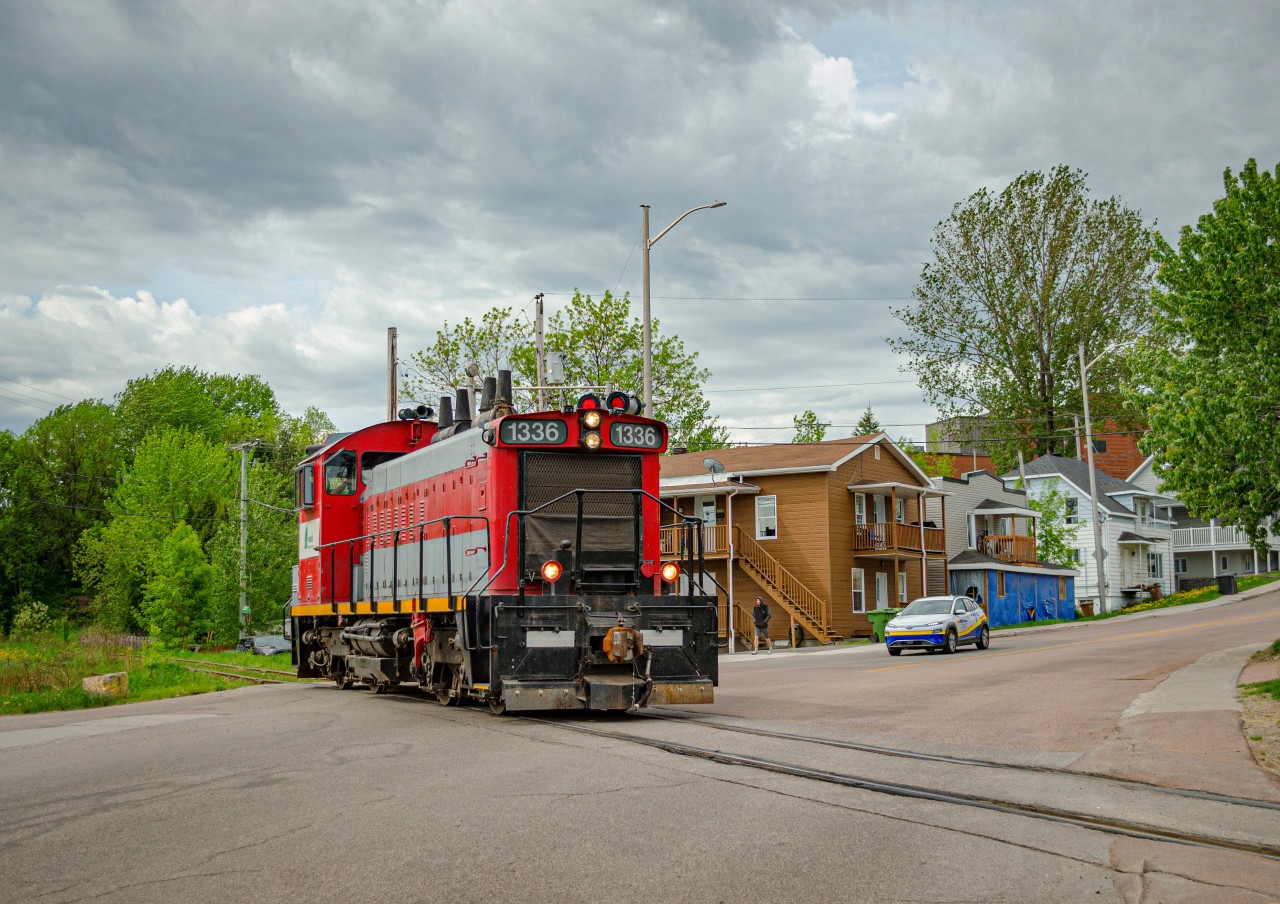 Resolute paper's switcher, a former Canadian National SW1200rs, rides the hill down to the paper mill after spotting cars at the CN interchange. This is a maneuver they will later repeat that day. Here we can see it crossing Rue St-Dominique.