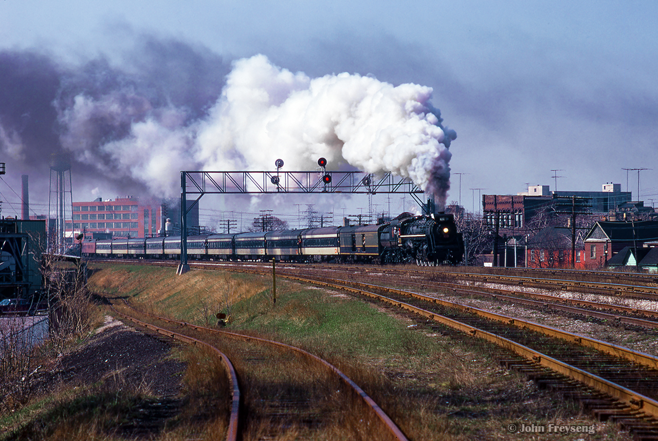 A few miles east of Union Station, an Upper Canada Railway Society excursion is bound for Lindsay behind CNR 6218.  Rolling beneath the signal bridge at mile 331.6 Kingston Sub, the excursion is passing the site of CNR's Riverdale station, hidden towards the rear of the train.

Scan and editing by Jacob Patterson.