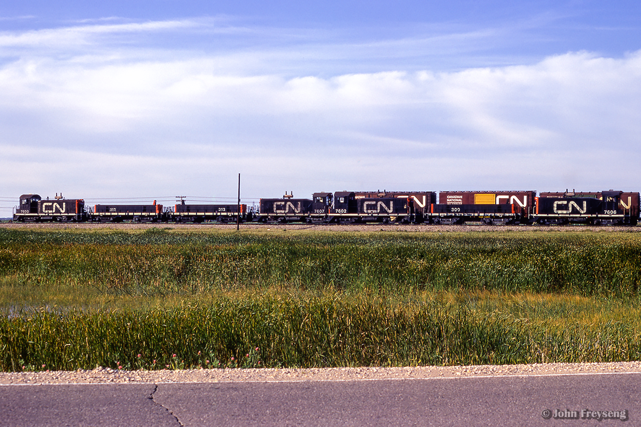 Two hump sets are seen working in Winnipeg's Symington Yard on a summer 1972 day.  Four GMD SW900s, paired up with three HBU-4s, rebuilt from MLW 8400-series S3 

Scan and editing by Jacob Patterson.
