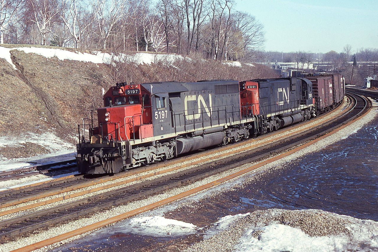Cold and crisp on this February morning at Bayview Junction. Didn't see much action (too cold) but at least this shot turned out nice. CN 5197 and 2001 westbound entering the Dundas sub from the Oakville. The 5197 (SD40) was sold to Connell Leasing (GEC Alstom) in 1997 and the trailing 2001 (MLW C-630M) was retired by 1996.
For some odd reason while recording the month, I forgot to write down the day.