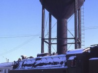 CN 6077 as it arrived at Capreol, Ontario in February 1967. The water tank seems to be saying: "Hello again 6077!!! It has been a long time since I last filled your tank. But what is with that small square thing behind you?? What happened to your vanderbilt tender?"
6077 was quickly taken inside the roundhouse where it was repainted and refitted with a proper vanderbilt tender (from 6136??) in preparation for display in Prescott Park.