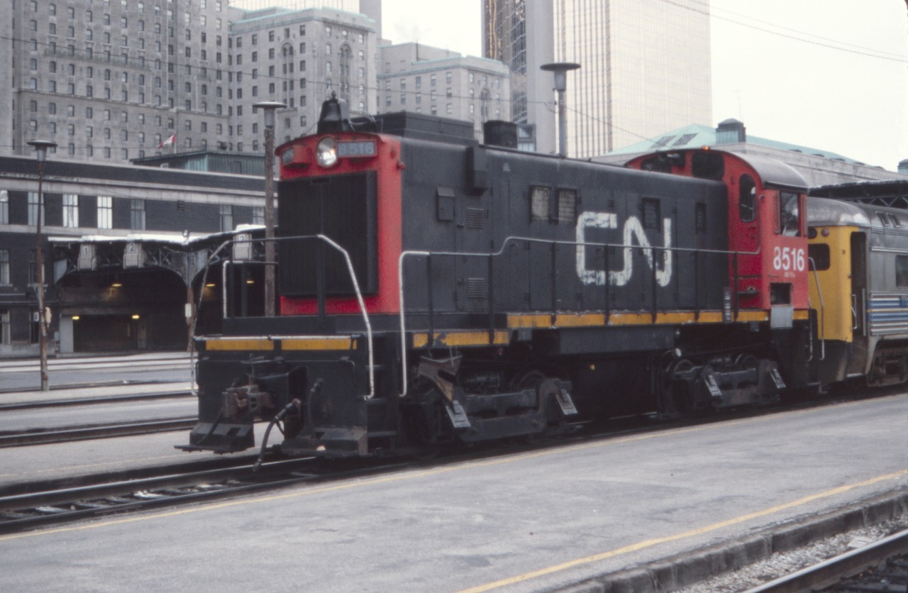 A switch crew with CN 8516, a MLW S-13 built in 1959, spots the Via RDC cars at the west end of Toronto Union Station in this August, 1984 view. The imposing stone edifice in the distance is the famous Royal York Hotel. We stayed there once, with a view overlooking the station, and I recall looking down from our room and seeing an extremely long streamliner passenger train that hung out both ends of the trainshed. Not sure why I didn't take a picture? Just to the right of the Royal York is the gold-colored Royal Bank Plaza tower, which used some real gold to manufacture the window panes.