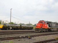 On a rainy Sunday morning, a CN yard assignment (powered by SD60 5402 and SD40-2W 5279) shuffles cars at West Jct near Walker Yard as preserved units 6514 and 6614 look on. Now owned by the Alberta Railway Museum, these F units have an interesting history--they were built for CN in 1957, acquired by VIA in 1978, later sold to the Algoma Central (numbers 1753 and 1762), and retired again in 2001 before being donated the Museum in June 2003. They will be exhibited at the "Christmas in the Rockies!" charity event in Jasper on 2 August 2025 (11:00 AM to 5:00 PM, Jasper CN station).