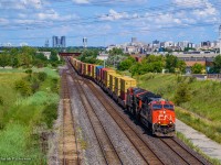 CN Z149 from Montreal crosses over to the bypass at Snider en route to Brampton Intermodal.  Overall not a ton of differences when compared to <a href=https://www.railpictures.ca/?attachment_id=57017>John Freyseng's 1986 view.</a>