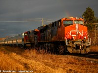 CN 875 originated at Fort Erie. Brand-new grain cars from National Steel were sent to Mac Yard. I caught them going through St. Catharines in the evening after rain showers passed through with a rainbow.